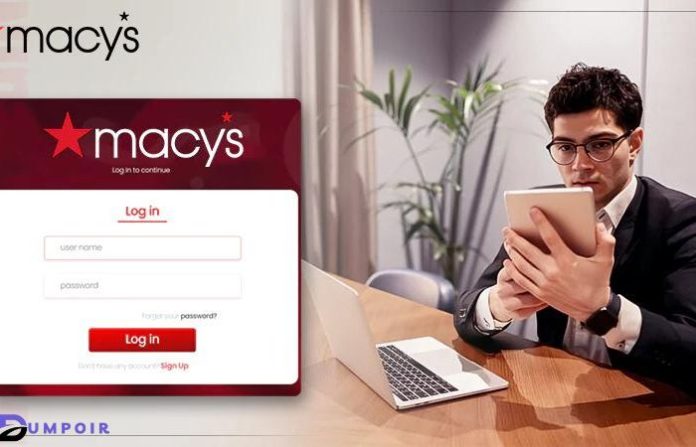 Macys Insite -A man in a suit working on a laptop at a desk.