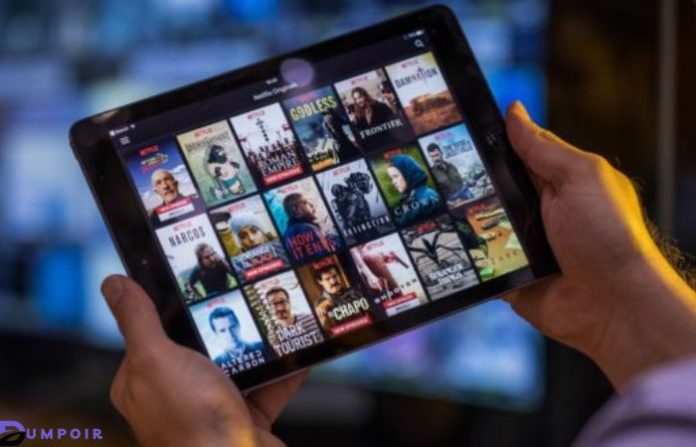 Person holding iPad showing movie screen - UwatchFree Movies - 6 Best Alternatives of uwatchfree